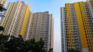 High-rise residential buildings with multiple balconies and a clear sky. - Springlake Apartment Summarecon by Veeroom by Zuzu (Bekasi)