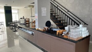 A clean, modern breakfast area with a counter, seating, and a staircase.