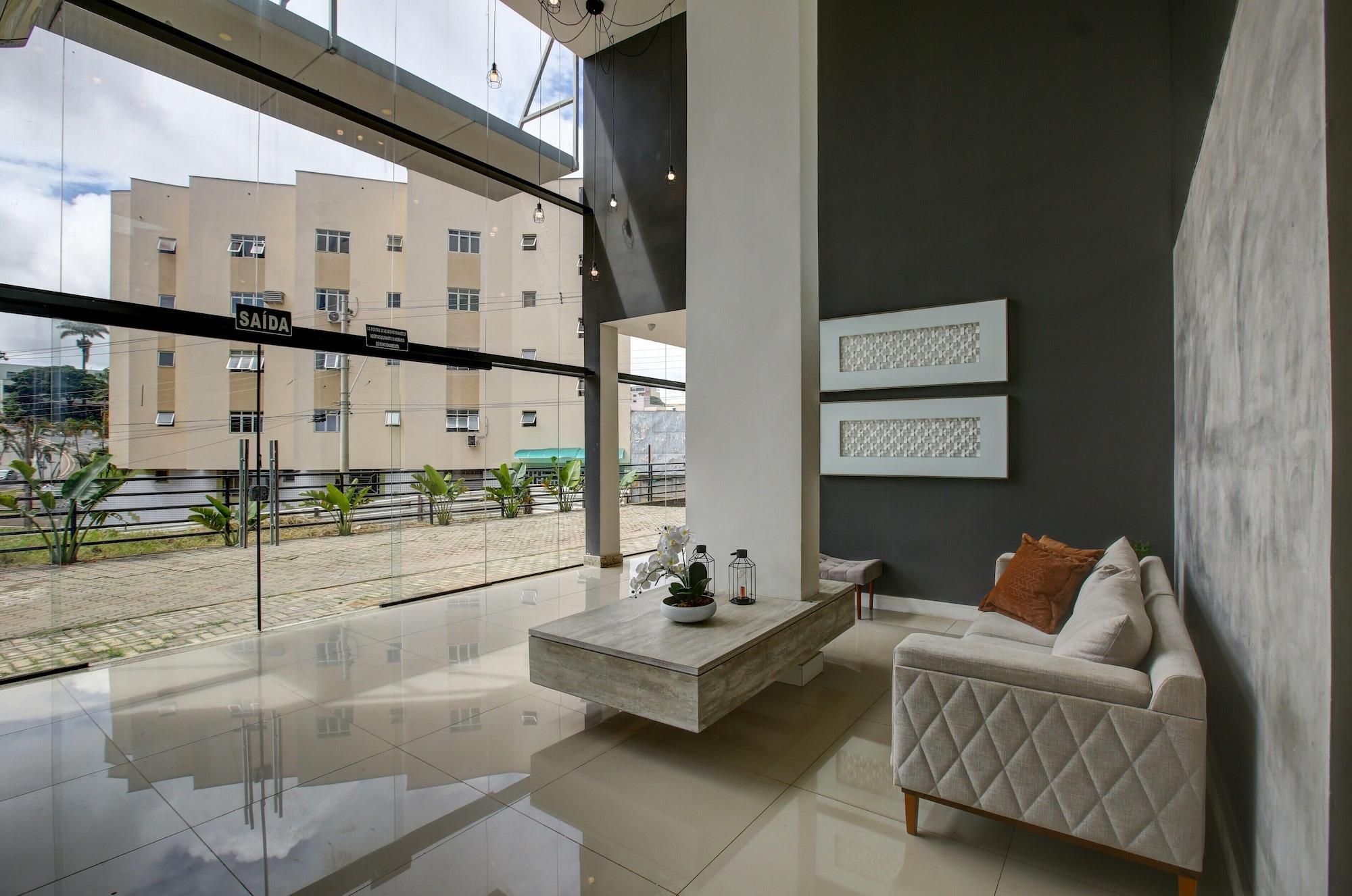 A modern living room with a sofa, coffee table, and artwork on the wall.