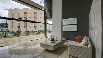 A modern living room with a sofa, coffee table, and artwork on the wall.