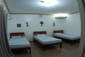 A room with three single beds, a ceiling light, and a small wall-mounted decoration. - Hanbee S Resort (Puerto Princesa)