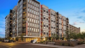 A multi-story hotel with a modern architectural design, featuring balconies and a parking area. - Locale Midtown Phoenix (Phoenix)
