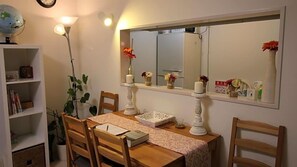 A dining area with a wooden table, chairs, a globe, and a bookshelf. - Coco Shinjuku Hotel (Tokyo)