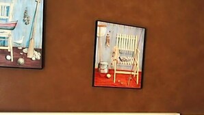 A bedroom with a bed, a nightstand with a vase of flowers, and two paintings on the wall. - Hotel Posta (Ventimiglia)