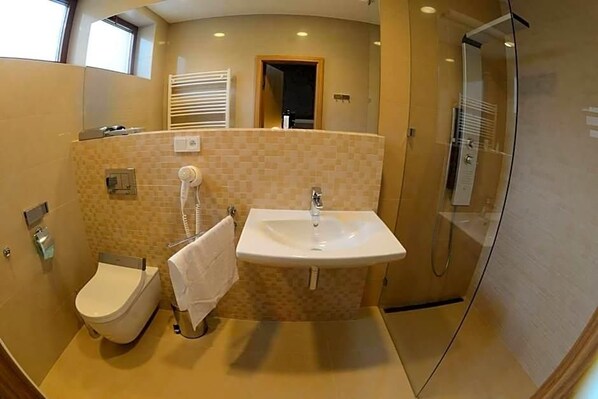 A bathroom with a toilet, sink, and shower. - Hotel Stardust (Nove Zamky)