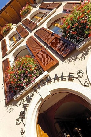 A building with a sign reading 'BARR'S HALL' and multiple windows with wooden shutters. - Garnv Hotel Tignale Gtsgroup (Tignale)