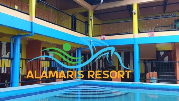 A multi-level building with a swimming pool, balconies, and a sign reading 'ALAMARIS RESORT'. - Alamaris Resort (Morong)