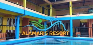A multi-level building with a swimming pool, balconies, and a sign reading 'ALAMARIS RESORT'. - Alamaris Resort (Morong)
