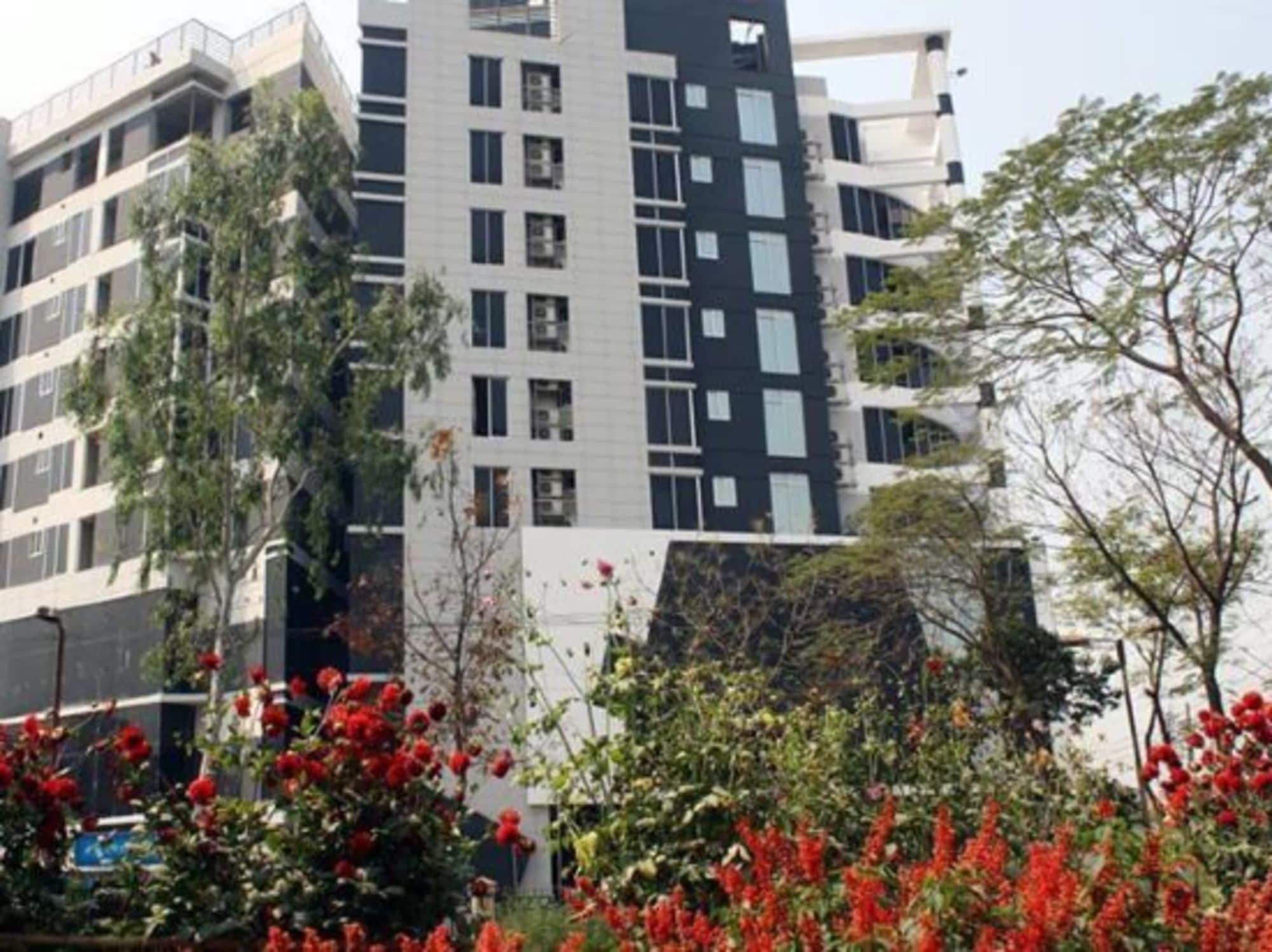A multi-story building with a modern architectural design, featuring a mix of glass and concrete facades.