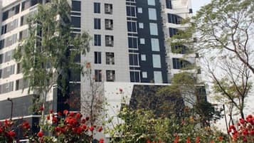 A multi-story building with a modern architectural design, featuring a mix of glass and concrete facades.
