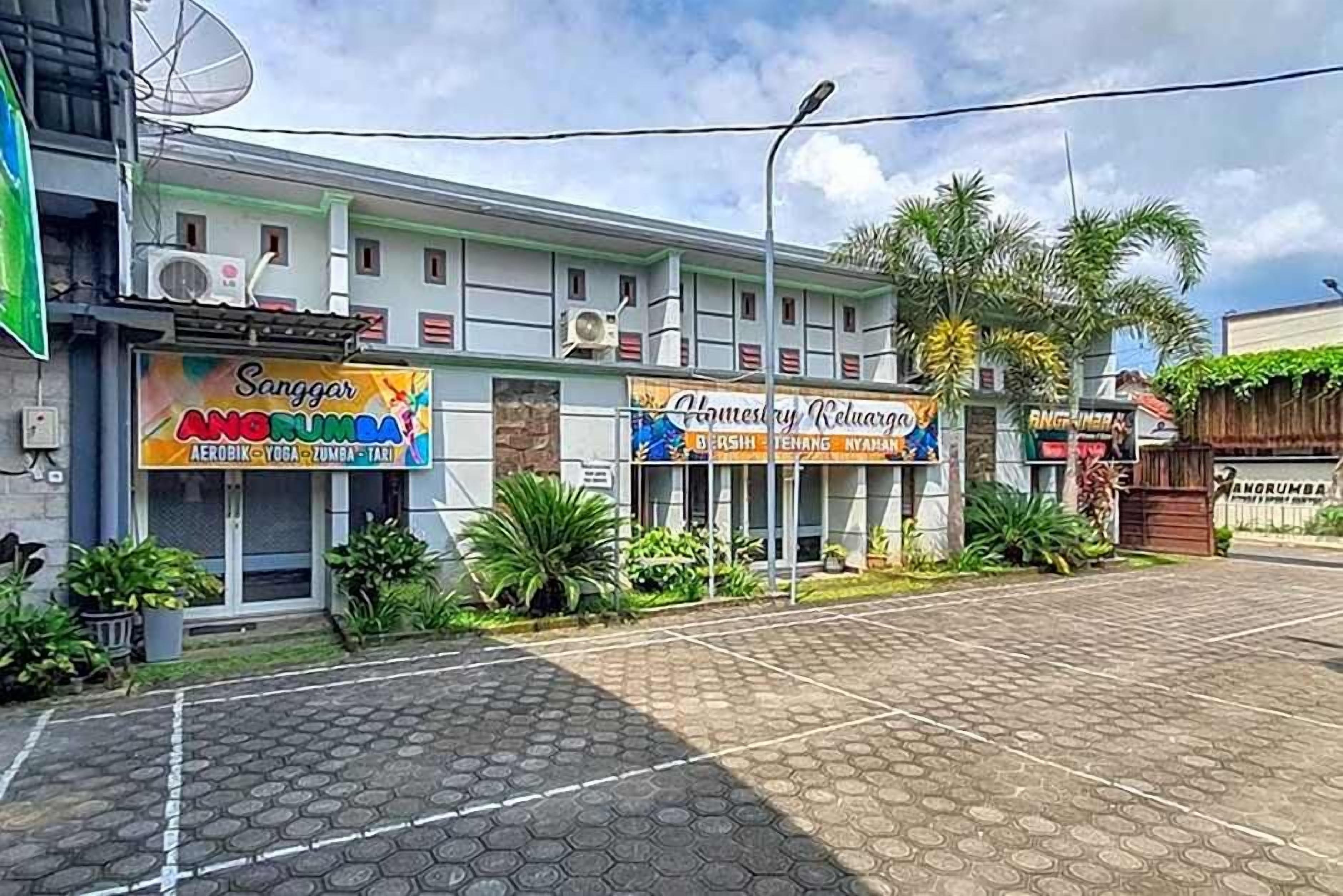 A building with multiple commercial establishments, including a yoga studio and a homestay.