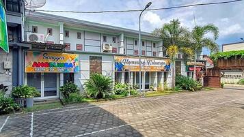 A building with multiple commercial establishments, including a yoga studio and a homestay.