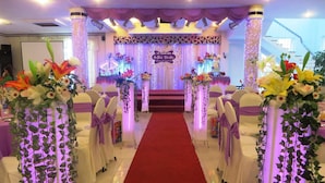 A wedding ceremony aisle with floral decorations and a red carpet. - Hung Vuong Hotel (Tuy Hoa)