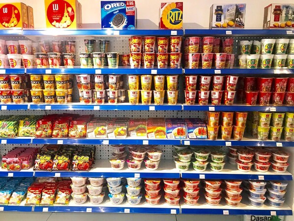 A grocery store aisle with various food products on shelves. - Kim Oanh Orchids Hotel (Da Lat)