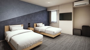 A modern hotel room with two beds, a flat-screen TV, an air conditioning unit, and a window with sheer curtains. - GRAND HOSTEL LDK Hiroshima (Hiroshima)