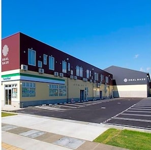 A building with a sign reading 'OGAL BASE' and a parking lot in front. - Ogal Inn - Vacation Stay 01855v (Shiwa)