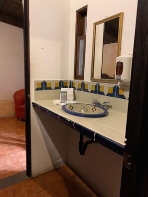 A bathroom with a sink, mirror, and hand dryer. - Hotel T Kon T (Antigua Guatemala)