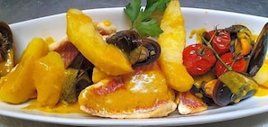A seafood dish with mussels, shrimp, and tomatoes. - Auberge De La Table Ronde (Vinon-sur-Verdon)