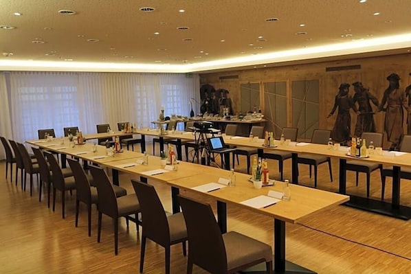 A conference room with long tables, chairs, a laptop, and a projector. - Hotel Goldener Hirsch (Kaufbeuren)