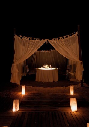 An outdoor dining setup with a table and chairs under a canopy. - Ritz Barra De São Miguel (Maceió)