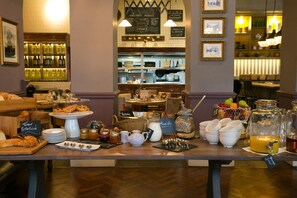 A breakfast buffet with various food items and beverages. - Dog And Fox (London)