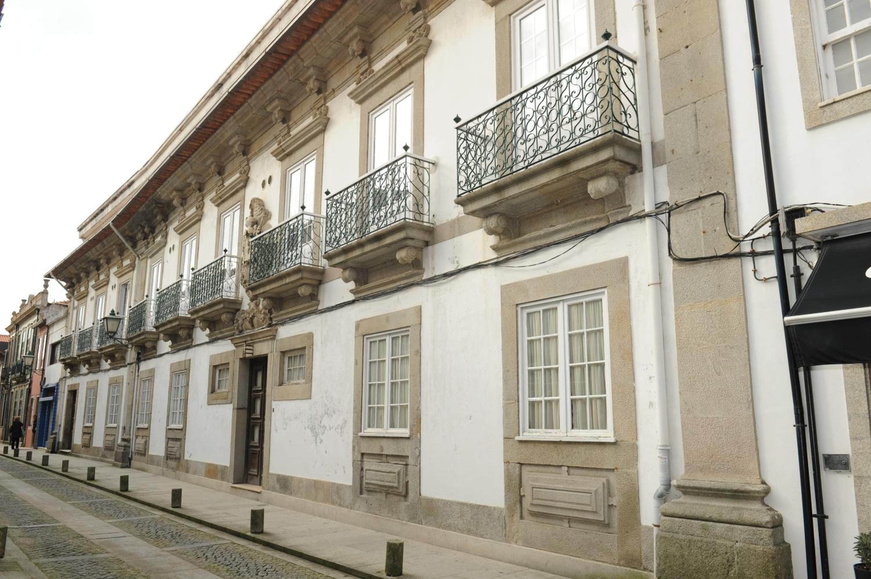 A building with multiple windows and balconies, featuring classical architectural elements.