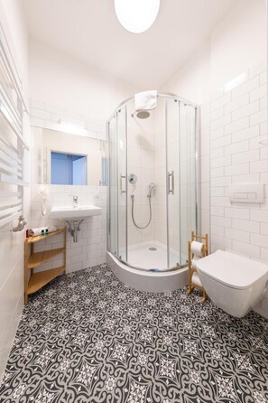 Une salle de bain moderne avec une douche à parois de verre, un lavabo et une baignoire.