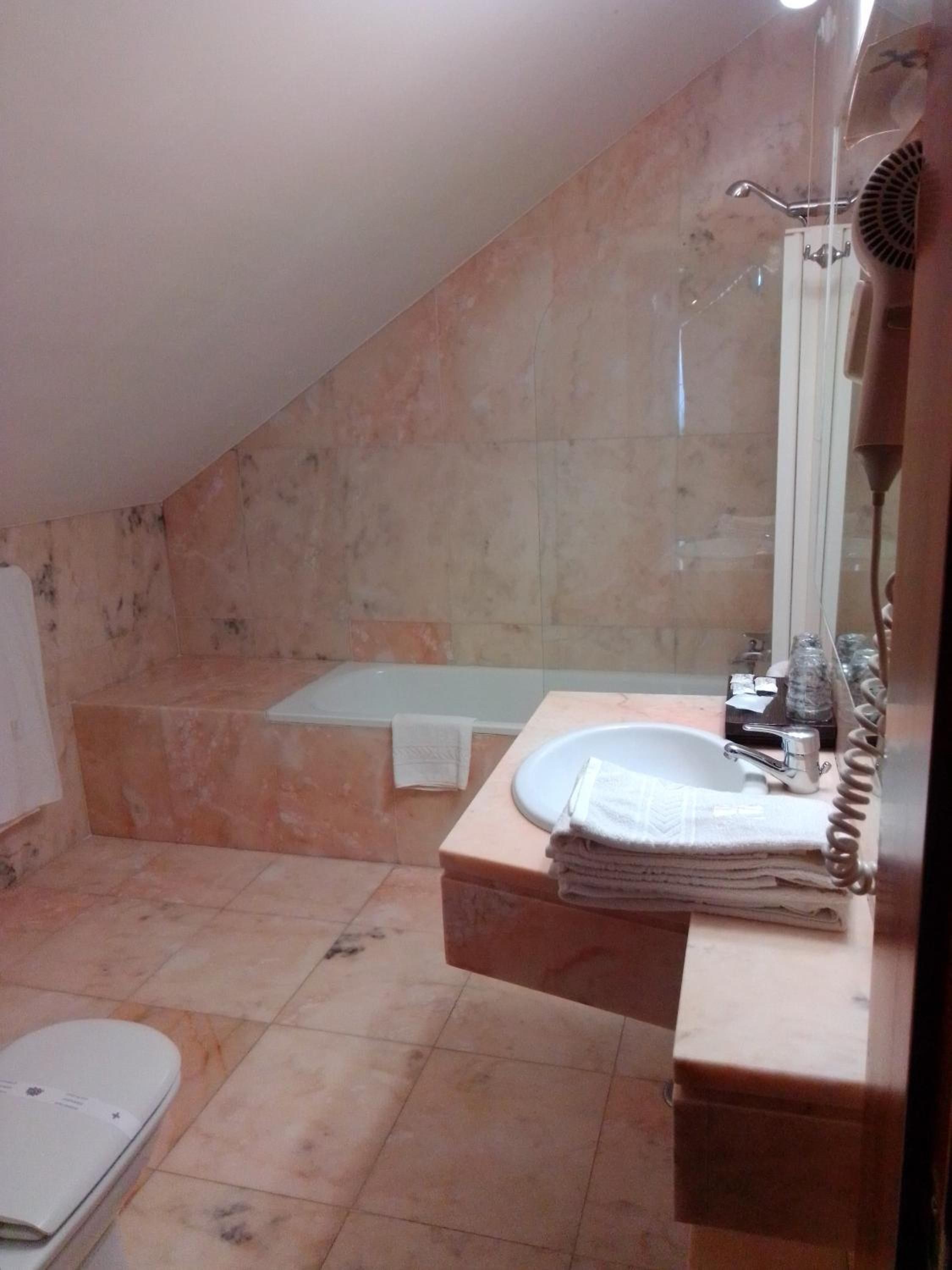 Ein Badezimmer mit Waschbecken, Spiegel und Dusche.