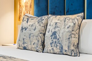A bed with two pillows and a blue headboard. - Hotel Holloway (Birmingham)