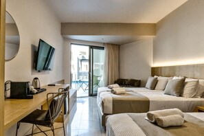 A hotel room with a bed, a desk, a chair, a television, and a view of the outside.