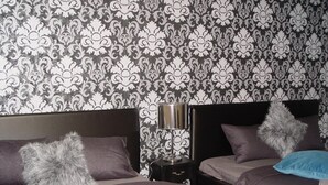 A bedroom with two beds, a nightstand, and a lamp. - Neklanova Apartments (Prague)