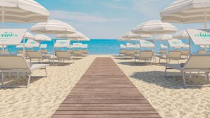 A beach with a wooden walkway leading to beach chairs and umbrellas, each labeled with 'Hotel Village.' - Eraora Hotel Village (Battipaglia)