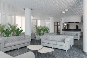 A modern interior with tufted sofas, a central white column, and a marble floor. - Eraora Hotel Village (Battipaglia)