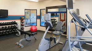 A gym with treadmills, a bench, dumbbells, and exercise balls. - Larkspur Landing Hotel South Bend (South Bend)