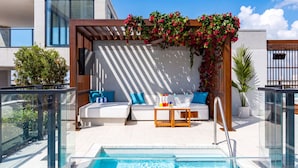 A rooftop pool area with a seating area, a pool, and a view of the city. - The E11EVEN Hotel & Residences (Miami)