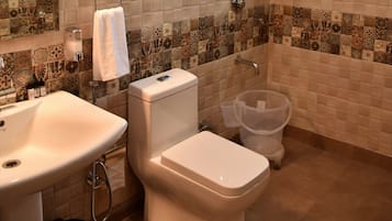 A bathroom with a sink, toilet, and shower.