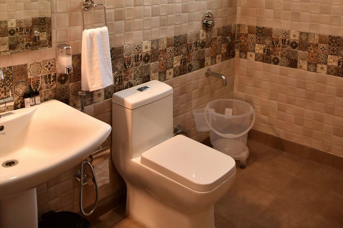 A bathroom with a sink, toilet, and shower.