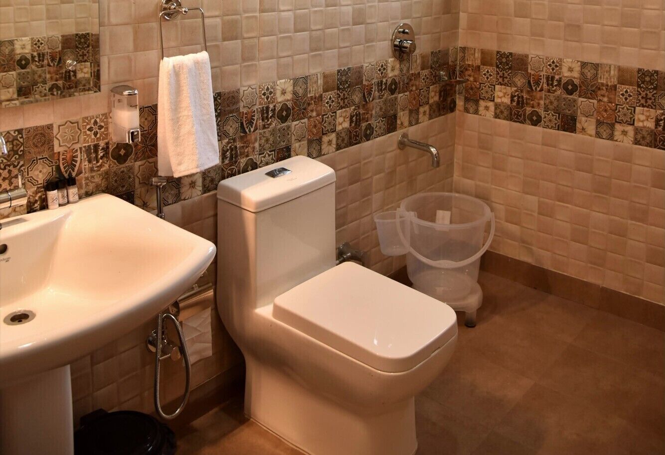 A bathroom with a sink, toilet, and shower.