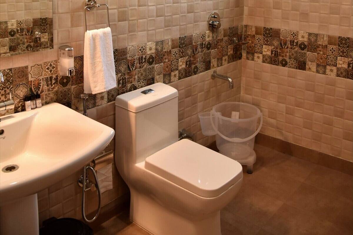 A bathroom with a sink, toilet, and shower.