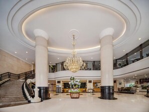 A spacious lobby with a grand chandelier, a staircase, and a reception desk. - Grandskylight Shenzhen Dapeng (Shenzhen)