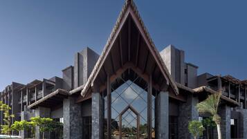 A modern building with a distinctive triangular roof and a large glass facade.