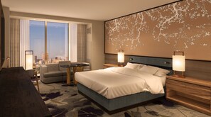 A hotel room with a bed, a desk, a chair, a view of the cityscape, and a decorative wall. - Nobu New Orleans (New Orleans)