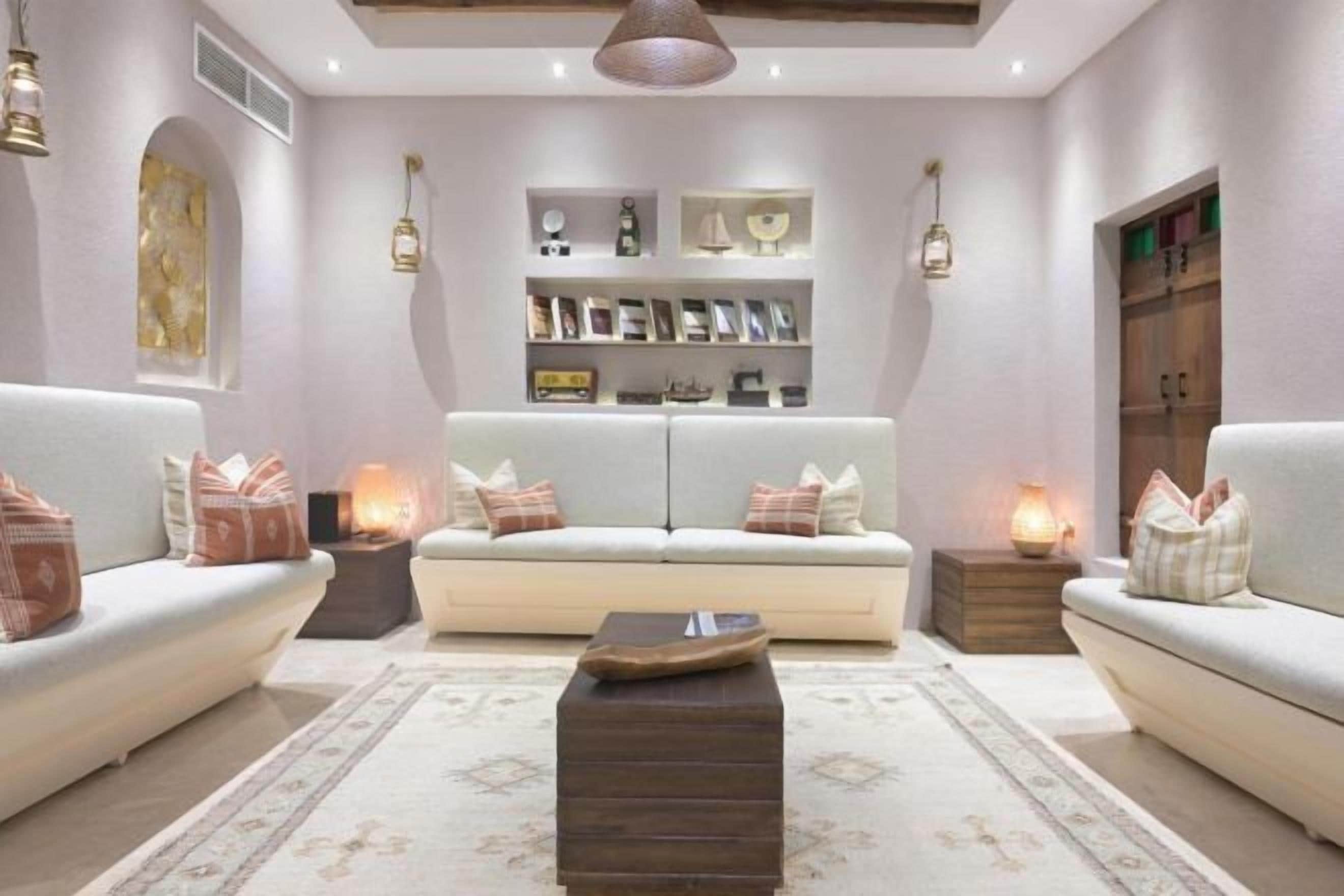 A modern living room with two sofas, a coffee table, and a bookshelf.