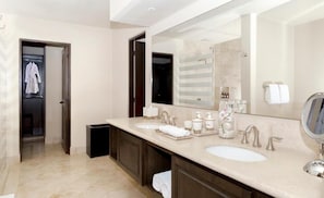 A modern bathroom with two sinks, a large mirror, and a walk-in shower. - The Reserve At Diamante Los Cabos (Cabo San Lucas)