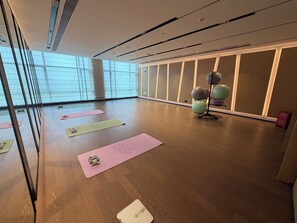 A spacious room with large windows, wooden flooring, and exercise equipment. - Grand Skylight Hotel Wuhan Optics Valley (Wuhan)