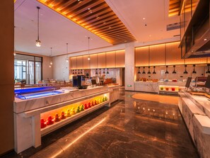 A modern kitchen with marble countertops, a central island, and pendant lighting. - Grand Skylight Hotel Wuhan Optics Valley (Wuhan)