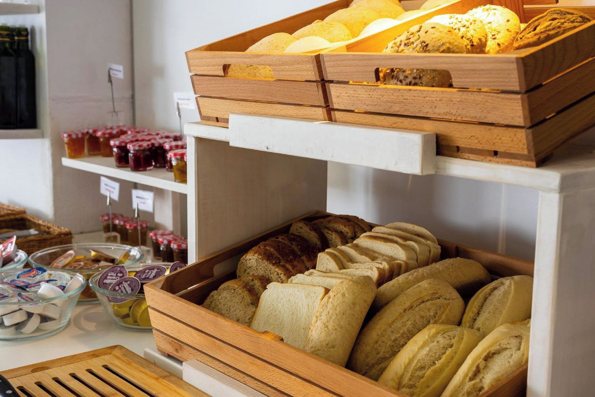 A bakery display with various breads and pastries.