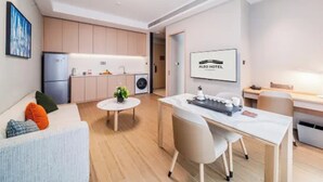 A modern hotel room with a kitchenette, a dining area, and a seating area. - Shanghai Also Hotel (Shanghai)