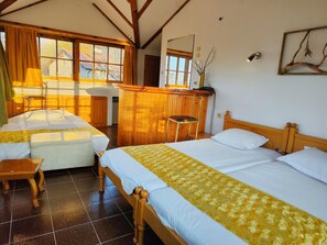 A room with two beds, a wooden desk, a chair, and a window with curtains. - Park Hotel Amfora (Sofia)