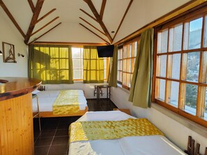 A room with two beds, a wooden desk, and large windows with curtains. - Park Hotel Amfora (Sofia)